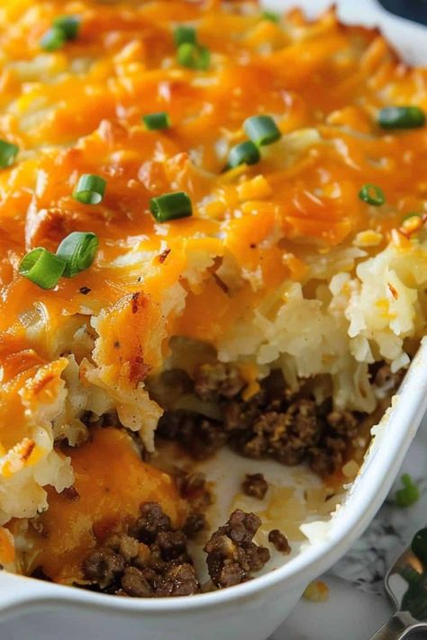 Closeup of half eaten cheesy hash brown casserole in baking dish on white countertop. Hamburger Hash Brown Casserole, Hamburger Hash, Best Chicken Casserole, Million Dollar Chicken, Hamburger Casserole, Creamy Potato Salad, Hash Brown Casserole, Dinner With Ground Beef, Fall Dinner Recipes