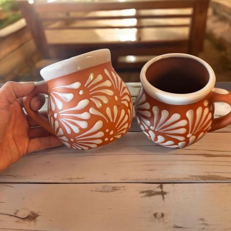 PRICES MAY VARY. Handmade Clay Mugs Beautiful white design on a terracotta background Enjoy your favorite beverages with this charming set of 2 Talavera mugs, each holding 12 ounces. Handcrafted by skilled Mexican artisans, these mugs feature a beautiful white design with a terracotta base. Perfect for coffee, tea, or any drink of your choice, these mugs bring a touch of vibrant artistry to your daily routine. Whether for personal use or as a unique gift, these mugs are a delightful addition to Hacienda Moderna, Terracotta Mugs, Mexican Pottery Decor, Talavera Kitchen, Terracotta Design, Dream Inspiration, Mexican Coffee, Painted Pots Diy, Mexican Ceramics