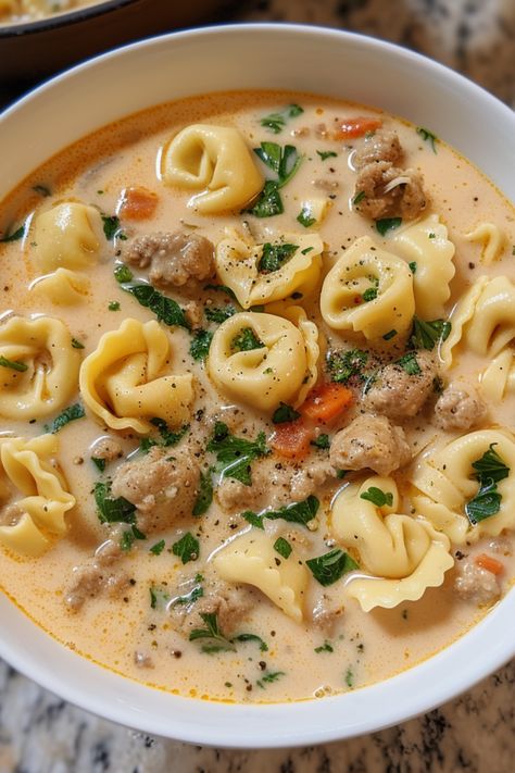 Enjoy the ultimate creamy sausage tortellini soup recipe, a deliciously easy and healthy meal with meat, vegetables, and dairy. Featuring Italian sausage for an authentic taste, it's the best way to warm up. You can prepare tortellini soup in a Crock Pot, instant pot, slow cooker, or stove top. Check out this tortellini soup recipe and more soup recipes at simplycalledfood.com. Ground Beef And Tortellini Soup, Tiktok Tortellini Soup, Creamy Sausage Tortellini Soup Stovetop, Sausage Tomato Tortellini Soup, Tortellini Hamburger Soup, Tortellini Soup Easy Quick, Cheeseburger Tortellini Soup, One Pot Creamy Sausage Tortellini Soup, Creamy Tortilini Soup