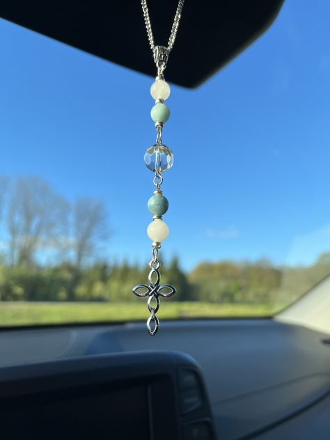 "Decorate your car with our rearview mirror Blue Jade and White Quartz Cross sun catcher car charm! Perfect for hanging from your rearview mirror. It will brighten up your day hanging from your mirror, purse, window, or anywhere else you would choose to hang it from. This would also make a great gift! These beads will sparkle in the sunlight! All of our products are made with high-quality glass, natural stone, or crystal beads.  Length of charm: 4 1/2\" Length of Chain from end to end: 7 Inches Visit us at https://www.etsy.com/shop/BWCharms?ref=shop_sugg for more beautiful car charms to choose from Please like us on Instagram! Instagram.com/beautifullywildllc  If you don't see something you are looking for, we do take special requests. Thank you for shopping our small business, we are happ Rearview Mirror Charms Diy, Beaded Car Mirror Hanger, Car Charms Diy, Car Rear View Mirror Decor, Mirror Purse, Beaded Car Charms, Car Mirror Decorations, Crystal Car Charms, Car Hanging Accessories