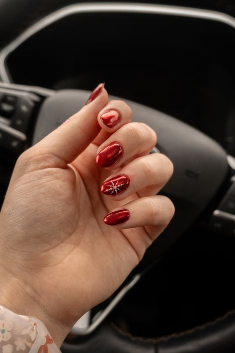 My nail girl NEVER misses! This is gorgeous red chrome nails with a little snow flake accent nail on the ring finger. Christmas Nails Simple Almond Shape, Christmas Nail Ideas Chrome, Red Nails With Accent Nail Christmas, Red Chrome Snowflake Nails, Red Snowflake Nails Short, Christmas Red Gel Nails, Red Christmas Nails Chrome, Christmas Red Nail Ideas, Red Nails With Christmas Tree