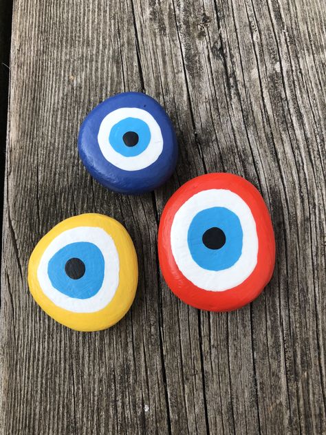 Evil Eye Rock, Evil Eye Painted Rocks, Evil Eye Rock Painting, Painted Stones And Rocks, Evil Eye Diy, Tulip Decor, Evil Eye Art, Painted Pebbles, Diy Rock Art