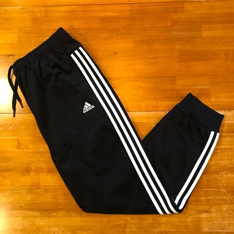 Classic Black Adidas Track Pants With 3 Stripes Down Each Leg, Hip Pockets, Elastic/Drawstring Waist, And Cuffed Hems. Has The Adidas Badge Of Sport Logo On Left Thigh. Nwt. Qt63s18br Adidas Trousers, Pants Adidas, Striped Sweatpants, Sweatpants With Pockets, Joggers Track Pants, Adidas Windbreaker, Cuffed Joggers, Adidas Track Pants, Adidas Sweatpants