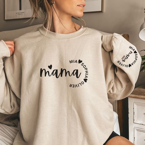 🌟Embrace the joy of motherhood:  Introducing our Mama Sweatshirt with Kids Names on Sleeve.  A cozy embrace of warmth and memories crafted for every occasion.  This personalized Mama Sweatshirt is a canvas for your unique story. The soft, durable fabric promises comfort in every season.🌟 🧡Designed with love, our Mom Sweatshirt With Kids Names becomes your personalized masterpiece that will soon become your go-to favorite.  🌱🌿But it's not just the message that makes this sweatshirt special; Loose Hoodie, Retro Sweatshirts, Mom Hoodies, Boho Floral Dress, Cartoon Outfits, Mama Shirts, Vintage Hoodies, Mama Sweatshirt, Mom Sweatshirt