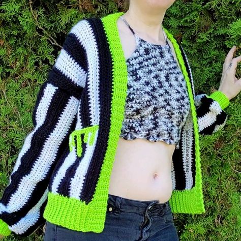 A black and white striped crochet cardigan with neon green trim & slime drips pockets Easy Goth Crochet, Crochet Drip Pattern, Free Crochet Patterns Wearables, Spooky Crochet Cardigan, Crochet Cardigan Halloween, Crochet Pattern Jumper, Halloween Crochet Patterns Free Clothes, Crochet Beetlejuice Cardigan, Halloween Sweater Crochet Pattern