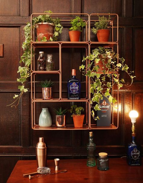 An open copper shelving unit is on the on-trend, chic way to display your favourite items. Trailing potted plants will work wonderfully here, as well as your favourite ornaments. (Photo: Slingsby Gin/Hotel Du Vin) Gin Room, Copper Shelves, Gin Display, Copper Display, Copper Shelving, Copper Pipe Shelves, Gin Garden, Copper Shelf, Bar Shelving