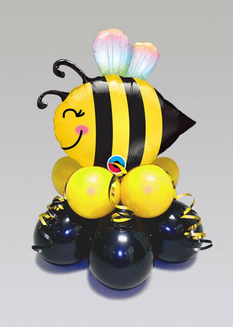 Inflated Bumble Bee Mini Balloon Table Centrepiece COMES INFLATED Description This fantastic bumble bee balloon centrepiece is perfect for a summer garden party. This centrepiece comes fully inflated and assembled. This features a mini sweet bee shaped foil balloon that is attached to a black and yellow 10 balloon base. This centrepiece measures approximately 40cm. Once inflated the balloon will last approximately 7 days. About Struts Based in Carlisle, Cumbria we have over 25 years experience i Bumblebee Centerpiece Ideas, Bumble Bee Centerpiece Ideas, Bee Centerpiece Ideas, Bee Display, Balloon Centrepiece, Balloon Base, Bee Themed Gender Reveal, Bee Balloon, Balloon Table Centerpieces