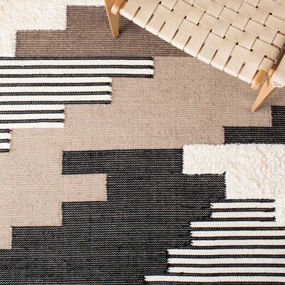 This hand woven area rug warms up your hardwood floors and delivers a rustic air to your living room. It's handmade from wool and cotton, and it pairs a geometric pattern inspired by Southwestern textiles in a palette of black, brown, and ivory hues. We love how the 0.2" pile height means it provides cushion underfoot but is still easy to vacuum. This area rug boasts a high-low pile mix to better define the pattern. Roll it out with a rug pad underneath to keep it securely in place. Rug Size: Ru Southwestern Contemporary Decor, Spindle Dining Chair, Wool Textures, Woven Area Rug, Lake Havasu, Area Rug Design, Boys Bedroom, Ivory Rug, Cotton Wool