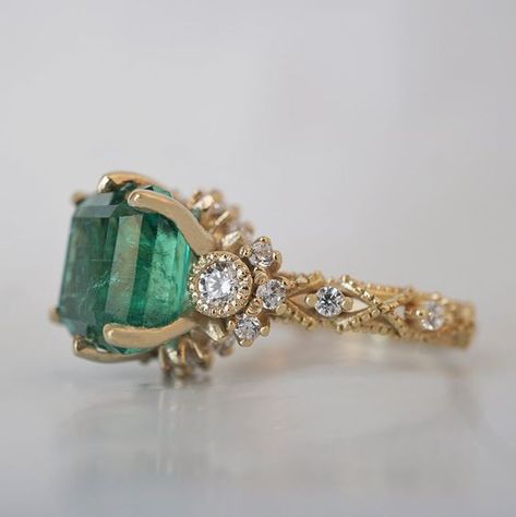 Bring elegance and sophistication to your jewelry collection with this one of a kind Emerald Knightsbridge Diamond Ring. Handcrafted in your choice of 14K and 18K Gold, this regal piece features a stunning natural emerald centerpiece surrounded by dazzling diamonds. As impressive as it is dreamy, this ring is sure to become a treasured family heirloom. Only one available. 14K or 18K solid gold Natural asscher cut emerald. 4.44 carat weight. Comes with a certificate. Natural round white diamonds. Emerald Wedding Ring Vintage, Emerald Engagement Ring Unique, Diamond And Emerald Ring, Gold Emerald Ring, Emerald Ring Vintage, Emerald Wedding Rings, Emerald Cut Diamond Ring, Emerald Ring Gold, Dope Jewelry