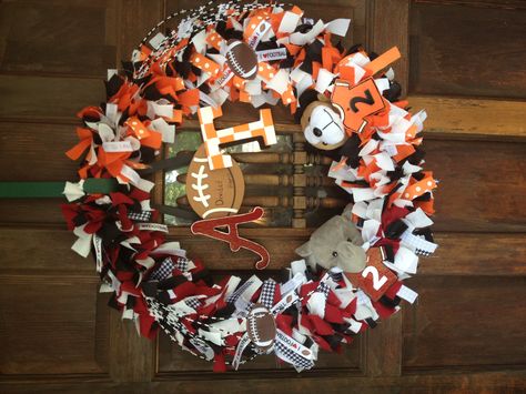 House divided wreath! Super easy to do! Use fabric and ribbon at 1 in wide and 6 ins long, and tie in knots around a metal wreath from any hobby store! House Divided Football Sign, Georgia Wreath Football Season, Virginia Tech Wreath, House Divided Wreath Ohio State, University Of Tennessee Wreath, House Divided Wreath, Diy Grapevine Wreath, Baseball Wreaths, Etsy Wreaths