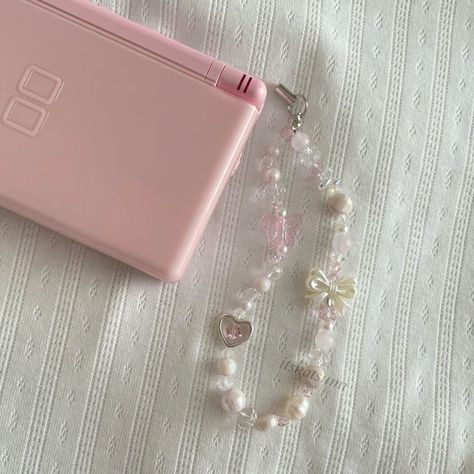 Camera Beads Strap, Phone Lanyard Aesthetic, Pink Phone Charm Aesthetic, Pink Phone Strap, Coquette Phone Charm, Pink Nintendo Ds, Phone Strap Aesthetic, Phone Charm Ideas, Phone Charm Aesthetic