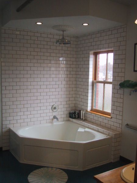 Tile surround, the wall and shelf, maybe wood board around the tub. Bath Tub Shower Combo, Corner Tub Shower Combo, Corner Bathtub Shower, Corner Tub Shower, Corner Jetted Tub, Bathtub Shower Combo, Open Showers, Small Tub, Corner Tub