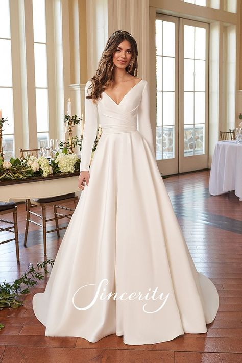 This long sleeve Mikado ball gown is a dress that will make you feel like royalty. It features a modest V-neckline with an open V-back. Pleating along the bodice slims the waistline and leads to a full, circular cut skirt. Pockets and covered buttons to the end of the chapel length train are the finishing touches to this charming bridal gown. Long Sleeve Silk Wedding Dress, Sincerity Bridal, Filipiniana Dress, Civil Wedding Dresses, Beach Wedding Dress Boho, Skirt Pockets, Bridal Ball Gown, Justin Alexander, Wedding Dress Fabrics