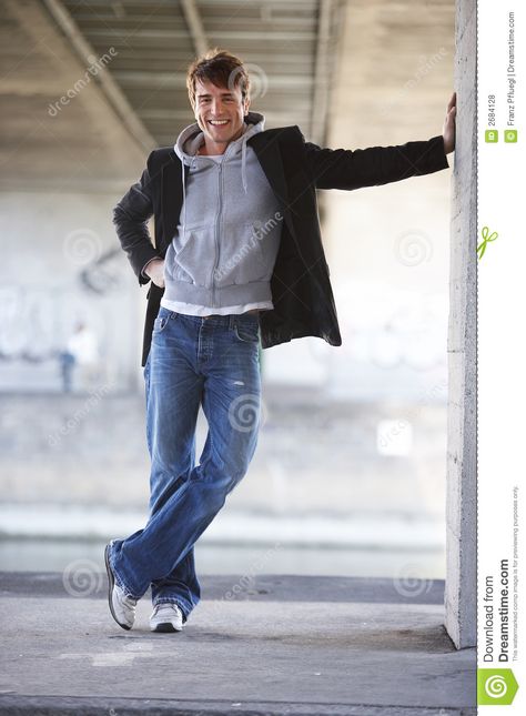 To laugh. One handsome, smiling man is leaning against a wall under a bridge #Sponsored , #ad, #Ad, #handsome, #wall, #bridge, #smiling Leaning On Wall Pose Drawing, Lean Pose Reference, Man Leaning Against Wall Reference, Guy Leaning Against Wall Reference, Leaning On Door Frame Pose, Male Leaning Against Wall Pose Reference, Guy Leaning On Wall, Wall Leaning Pose Reference, Person Leaning On Wall