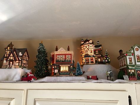 More of my village. Christmas Village Over Kitchen Cabinets, Christmas Village Above Kitchen Cabinets, Christmas Village On Top Of Cabinets, Diy Christmas Village Displays, Holidays Decorations, Christmas Village Collections, Diy Christmas Village, Halloween Christmas Decorations, Kitchen Lights