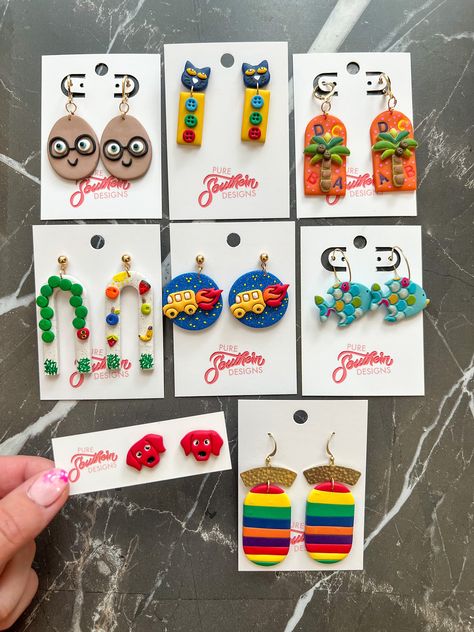 *PRE-ORDERS can take up to 1-2 weeks to make.  *Every earring is handmade with love by me. Each piece is designed, created, mixed, sanded, and assembled in my home. They are made from polymer clay, which is lightweight and a fun way to spice up your outfits. Since each piece is one of a kind there may be some variations/imperfections within the colors and/or shape (each creation may differ slightly from the photos). *All earrings are made with nickel free/hypoallergenic backings and/or findings. *How to clean clay: use a cotton swab with acetone. *How to clean brass: use Brasso and ketchup. *How to store: in a cool, clean, dry area. *Avoid: water, bending, perfumes, etc. Book Clay Earrings, Teacher Earrings Clay, What To Make Out Of Clay, Funky Clay Earrings, Bookish Earrings, Polymer Clay Earring Ideas, Earring Photography, School Earrings, Water Bending