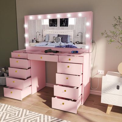 Create the ultimate glam room in your space with this lighted vanity. It features 11 drawers with crystal-inspired knobs that provide all the storage you need for beauty essentials, jewelry, and hair products. Plus, it features built-in Hollywood-style light bulbs around the mirror, allowing you to achieve your ideal look. This spacious vanity is made from engineered wood with a crisp white finish. A glam glass top adds an elegant touch. Plus, it comes with a USB port and a power outlet that let Makeup Vanity Lighting, Pink Vanity, Makeup Vanity Set, Lighted Vanity, Bedroom Makeup Vanity, Vanity Table Set, Make Up Desk Vanity, Big Mirror, Small Vanity