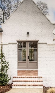 White Brick House With Brown Roof, White Brick Entryway Exterior, Cream Exterior Brick, Cap Cod Exterior Paint Colors, Creamy Brick Exterior, White And Taupe House Exterior, Cromwell Gray Exterior, White Brick House Tan Trim, White House Taupe Door