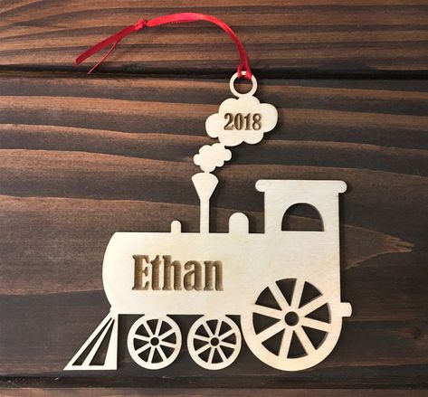 TO ENSURE DELIVERY IN TIME FOR CHRISTMAS ALL ORDERS MUST BE RECEIVED BY DECEMBER 16. Is your little one into trains? Why not get them a special train ornament with their name on it? This personalized ornament is made for 1/8 inch baltic birch and measures approximately 3 1/2 x 3 1/2 inches. It is laser engraved with their name and the year. The ornament comes in a personalized box for storage that will keep it like new for years to come.  When ordering please remember to give the name you want o Rock Engraving, Ornament Painting, Train Christmas, Train Ornament, Box For Storage, Clay Ornaments, Toy Train, Christmas Delivery, Polymer Clay Crafts