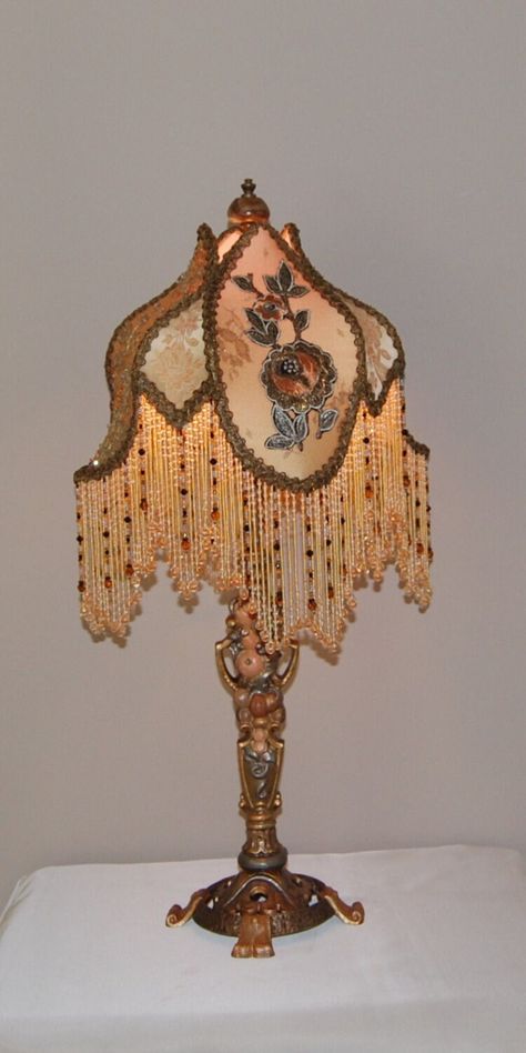 Here is a  classic Antique Victorian Cast Iron Lamp depicting fruit and nuts. It is pared with a "Tulip" shade rich with unique detail.  First it is lined and then covered in ombre dyed Silk Charmeuse.  Alternate panels are topped with;  Antique Hand Made Metal Lace embellished with crystals, and Vintage Metallic Net overlaid with wonderful 1920's Silk & Metal Appliques. The insert panels are covered in Antique French Silk Brocade. Vintage Metal Trim and Hand Beaded Glass Fringe repeat the warm Victorian Artifacts, Weird Lamps, Victorian Lamps, Victorian Bedroom, Victorian Lampshades, Tiffany Lighting, Decor Lamp, Victorian Furniture, Iron Lamp