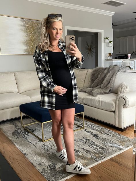 Simple black maternity dress with flannel and superstars Maternity Black Dress Outfit Casual, Maternity Dress With Flannel, Black Maternity Dress Outfit, Black Dress And Flannel Outfit, Black Dress With Flannel, Dress And Flannel Outfit, Dress With Tshirt, Dress With Flannel, Black Sweater Dress Outfit