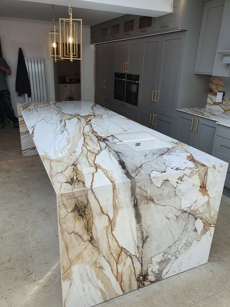 White Gray Marble Countertops, Calcutta Porcelain Countertops, Dramatic Marble Countertops, Waterfall Granite Countertops, Marble Kitchen Countertops Color Schemes, Statement Island Countertop, Bold Kitchen Countertops, Bold Countertop Kitchen, Dramatic Quartz Countertops