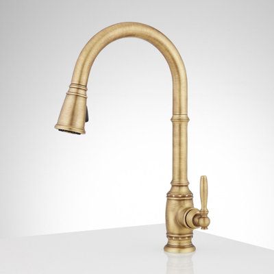 Give your kitchen the ultimate traditional centerpiece with the Pull-down faucet. Its high-arch, gooseneck silhouette is equal parts stylish and functional and offers plenty of clearance for larger pots and pans. To make dishwashing and food prep even easier, its two-function sprayer allows you to switch between an aerated stream and a powerful spray while a single lever handle controls both water pressure and temperature. Additionally, its pull-down head makes rinsing hard-to-reach areas of you Brass Fixtures Kitchen, Brass Faucet Kitchen, Antique Brass Kitchen Faucet, Vintage Kitchen Faucet, Unlacquered Brass Kitchen Faucet, Soap Dispenser Kitchen Sink, Traditional Kitchen Faucets, Kitchen Updates, Southern Traditional