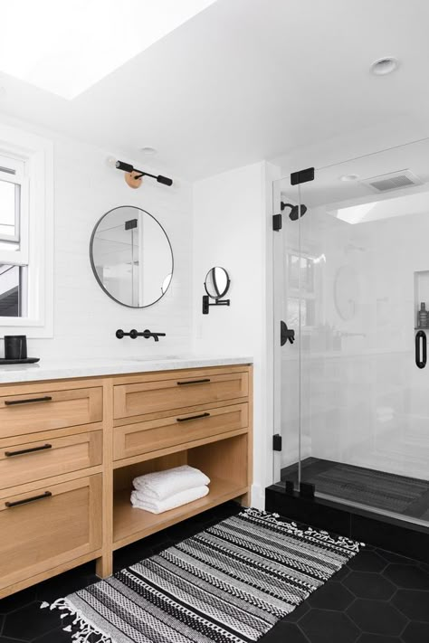 Bathroom Rift Oak Vanity with white marble top black matte hardware Black Round Mirrors Accentuated by Black Modern Sconces and Large Subway Tile on Walls Floor Tile is Large Black Hex Tile Bathroom #Bathroom #BathroomDesign #RiftOak #RiftoakVanity #whitemarble #blackmattehardware #BlackRoundMirrors #BlackModernSconces #LargeSubwayTile #FloorTile #LargeHexTile #BlackHexTile Black Hex Tile Bathroom, White Subway Tile Bathroom, Black Tile Bathrooms, Oak Vanity, Subway Tiles Bathroom, Bathroom Redesign, Boho Interiors, Boys Bathroom, Upstairs Bathrooms