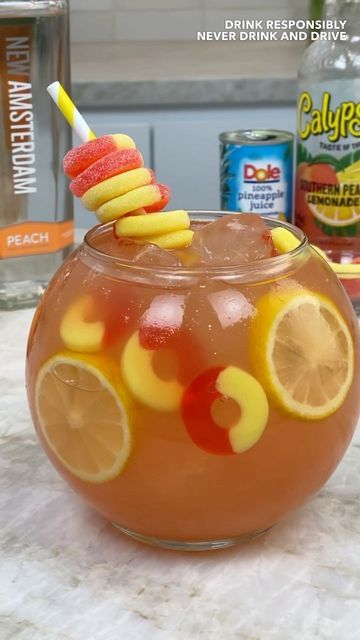 TIPSY BARTENDER 🍻🍹 on Instagram: "Crown Peach Fishbowl 🍑" Fishbowl Drink Mocktail, Diy Fishbowl Drink, Applebees Shark Bowl Drink Copycat, Kids Fishbowl Drink, Fish Bowl Drink Recipe, Fishbowl Recipes, Fish Bowl Drink, Fishbowl Cocktail, Fishbowl Drink