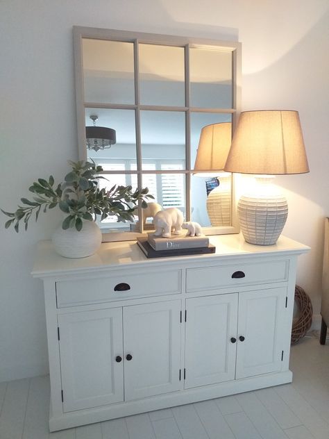 White sideboard with large grey mirror- simple look Grey Sideboard Decor, White Sideboard Decor Dining Room, Sideboard Styling With Mirror, Dining Room Decor Sideboard, Side Board Styling Living Room, Dining Room Sideboard Decor With Mirror, Sideboard Decor With Mirror, White Sideboard Styling, Lounge Sideboard Ideas