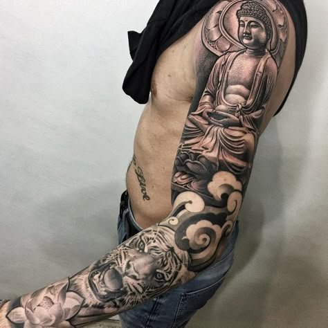 Tattoo uploaded by Tattoodo | Buddha tattoo by Lil B #LilB #buddhisttattoos #blackandgrey #realism #realistic #hyperrealism #clouds #tiger #junglecat #buddha #buddhism #pattern #lotus #stonework #sculpture #mudra #meditation | 492141 | Tattoodo Tiger Buddha Tattoo, Buddha Tattoo Arm Men, Realistic Buddha Tattoo, Buddha Tattoo Men, Japanese Buddha Tattoo, Buddha Sleeve Tattoo, Buddha Tattoo Design Ideas, Buddha Tatoo, Buddah Sleeve Tattoo