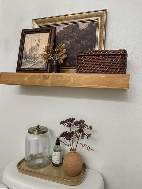 How To Decorate Small Bathroom Counter, Women’s Bathroom Organization, Half Bath Rental Decor, Floating Wall Shelf Decor, Above Toilet Picture Ideas, European Bathroom Decor, How To Decorate Above Toilet, Over Toilet Shelf Decor, Bathroom Decor Cottagecore