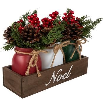 Full Dimensions (Varies Upon Shaping): 9" H x 10.94" W x 3.94" D Planter Dimensions: 5.25" H x 9.5" W x 2.5" D Plant Type: Pine Material: Glass, Wood, Plastic & Foam Color: Red, Green, Brown & White Care & Safety: Indoor Use Only Quantity: 1 Cultivate your space with festive faux florals, such as this Noel Berry & Pinecone Arrangement. This piece features three jars in the classic Christmas colors holding an assortment of faux foliage, berries, and pinecones. Around the neck of each jar, there is a jute bow, while the wooden box they sit in gives it a rustic look. The word "Noel" is written on the front in white script to spread holiday cheer. Display this at your next gathering along with complementary faux florals! Jar Christmas Decorations, Mason Jar Christmas Decor, Jar Christmas Decor, Mason Jar Christmas Decorations, Centerpiece Mason Jar, Birthday Candle Holder, Mason Jar Christmas, Chalk Paint Mason Jars, Jar Packaging