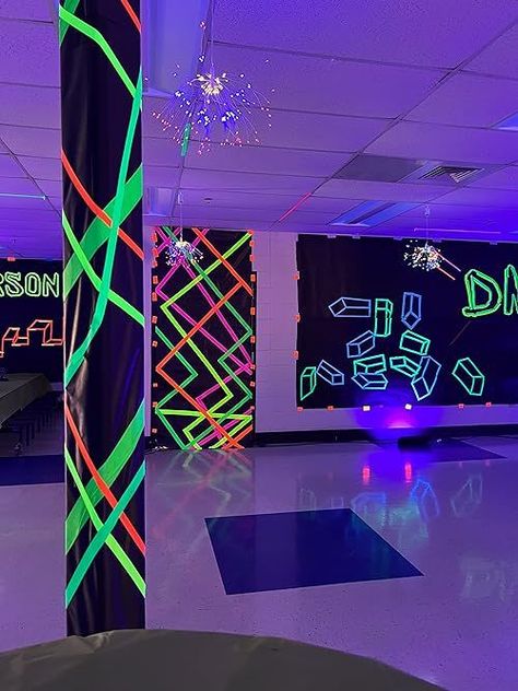 If you need neon party ideas, then you'll want to see this middle school dance decor! Throw a black and white party with glow in the dark tape, black school paper - it's an easy DIY party that glows in the dark! Neon Nights Homecoming, Pole Decorations Ideas Party, Elementary School Glow Dance, Glow In The Dark Ceiling Ideas, Halloween Glow Party Ideas, Glow In The Dark Party Activities, Glow In The Dark Prom Theme, Glow In The Dark Party Decor, Neon Party Photo Booth