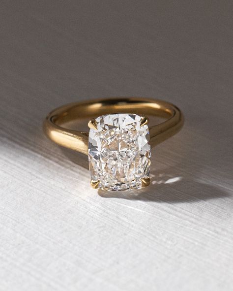 Heres a Micro Trend we noticed... or is it macro? 💍 📈 Elongated Cushion cuts! Whats the big deal? They have been spotted on A-listers like Kim Kardashian and Victoria Bekham but why not just wear a traditional cushion cut diamond, like Megan Markle did? We think they have gained recent popularity because they are the sweet middle spot between the gorgeous elongated shape of an oval cut (we all love) and the crushed ice brilliance of a radiant cut. The ratio that makes these so desirable... 4 Carat Asscher Engagement Ring, Thick Band Engagement Rings, Elongated Cushion Cut Engagement Ring, Unique Solitaire Engagement Ring, 2mm Wedding Band, Thick Gold Band, Elongated Cushion Cut, Timeless Engagement Ring, The Bling Ring