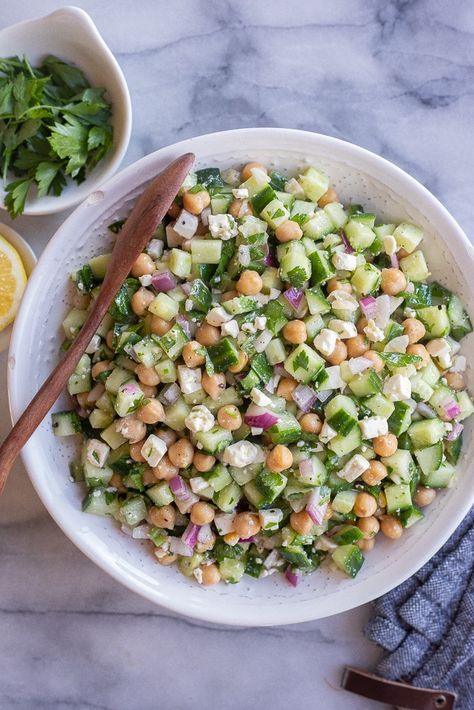 This Herby Cucumber Salad with Feta and Chickpeas is flavorful, refreshing and easy to make!  It's a great side dish for a potluck or BBQ, but is also delicious stuffed into a warm pita for lunch.  You only need a few simple ingredients to make this tasty summer salad! #summersalad #cucumbersalad #BBQSide #easyrecipe #vegetarian #chickpeasalad Cucumber Chickpea Salad Recipes, Potluck Recipes Salad, Cucumber Feta Pasta Salad, Chickpeas And Cucumber Salad, Chickpea Salads For Lunch, Creamy Cucumber Chickpea Salad, Simple Lunch Ideas Vegetarian, Herby Cucumber Salad With Feta And Chickpeas, Bbq Sides Dishes Healthy