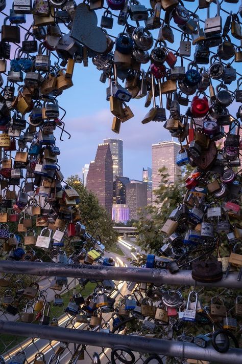 padlock in the shape of a heart. viewing angle is through the center of the heart looking at houston skyline. Downtown Houston Texas, Tv Setup, Love Lock Bridge, Lock Bridge, Tv Mounting, Houston Skyline, Tv Installation, Downtown Houston, Love Lock