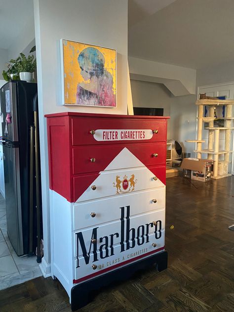 A dresser painted to look like a pack of Marlboro Red Cigarettes Fun Storage Ideas, Spicy Room Decor, Cool Room Wallpaper, Unique Home Furniture, Graffiti Furniture Ideas, Weird Aesthetic Room, Weird House Decor Diy, Bar Themed Room, House Decor Maximalism