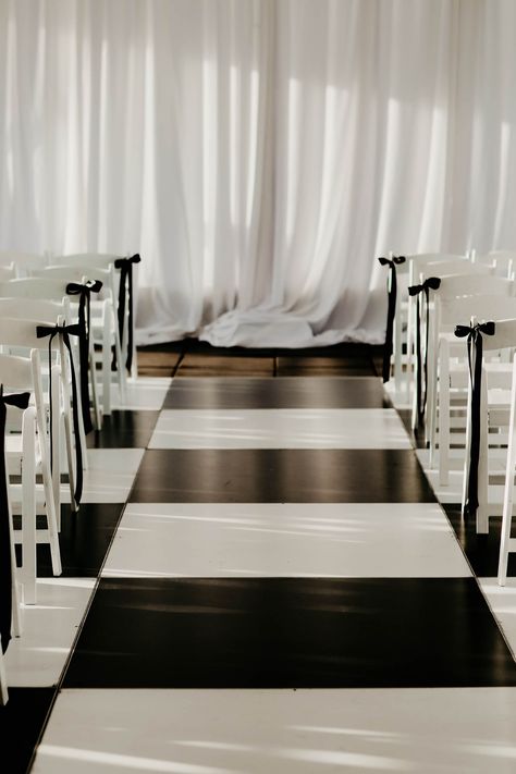 Black and White Wedding Dance Floor in Check Pattern Black And White Aisle Decor, Black White Minimalist Wedding, Bow Aisle Markers, Bows On Ceremony Chairs, White Ceremony Chairs, Elegant Ceremony Decor, Wedding Aisle Bows, Black Bow Wedding Decor, Black And White Wedding Aisle Decor