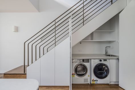 laundry under stairs laundry in the living, hidden laundry art deco stairs hardwood floor hidden laundry under stairs laundry cabinet white cabinet white laundry minimal laundry design small laundry integrated laundry sydney renovation Laundry Room Below Stairs, Laundry Room Design Under Stairs, Laundry Closet Under Staircase, Under Stair Utility Room, Under The Stairs Design Ideas, Laundry Under The Stairs, Under Stair Laundry, Washer And Dryer Under Stairs, Under Stairs Washing Machine