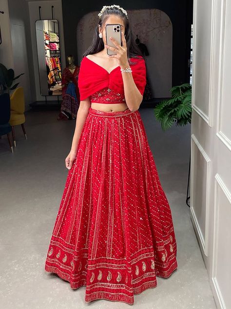 Introducing our appealing red sequins georgette party wear crop top lehenga! This exquisite outfit is designed to make you look absolutely stunning and steal the spotlight at any event. With its vibrant red color and intricate sequins and embroidery threadwork all over, this lehenga will showcase your impeccable taste and style. This lehenga is its red color georgette material, which adds a touch of elegance and sophistication to the overall design. The sequins and embroidery threadwork further