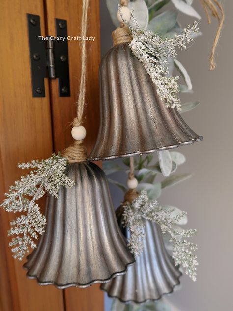 Make this DIY silver bell trio and transform plastic bells from the dollar store into high-end holiday decor Christmas Windchimes Diy, Bundt Pan Christmas Crafts, Diy Bejeweled Christmas Ornaments, Vintage Christmas Store Displays, Christmas Crafts For Decoration, Diy Dollar Tree Christmas Bells, Silver Bells Christmas Theme, Winter Wreath Diy Dollar Stores, Holiday Bells Decor