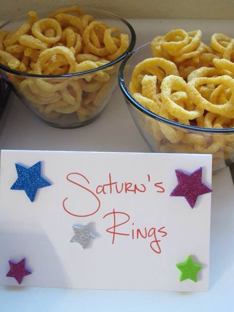 The outer space themed food menu Saturn's rings= funions Space Mocktails, Mars Themed Birthday Party, Space Themed Birthday Party Food, Space Themed Food, Nasa Party, Space Party Food, Space Vbs, Outer Space Baby Shower, Moon Birthday