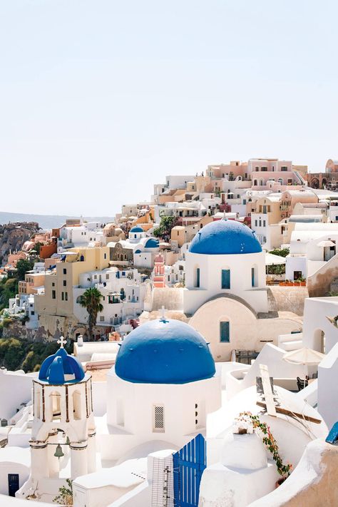 It's the most classic of all the classic Greek towns. Santorini's cliff-hugging Oia is the sweetest spot on the island. The white-washed buildings are scattered with blue dome churches, and secret lanes lead off the busy main thoroughfares to uninterrupted views of the sea. Evenings get busy with those seeking Santorini's famous sunsets – visit early to get the town to yourself. Greek Buildings, Hillside Villas, Greek Village, Greek Town, Best Greek Islands, Greek Blue, Greek Villas, Greece Summer, Building Aesthetic