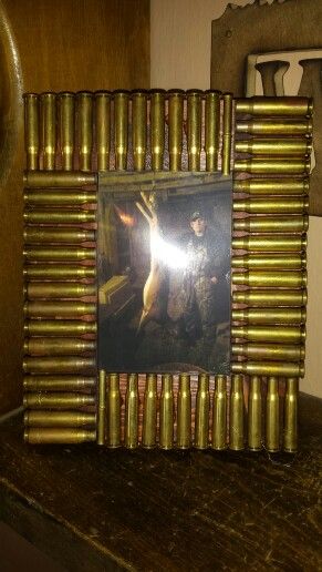 Bullet casing picture frame. I  bought a 4x6 frame from the craft section at walmart and we had some stain left over from doing our bathrooms. Then I had my husband save his shells for me. Add a little hot glue and done! Shotgun Shell Art, Shell Casings Crafts, Bullet Casing Crafts, Shotgun Shell Crafts, Hunting Crafts, Bullet Crafts, Bullet Art, Bullet Shell, Hunting Decor