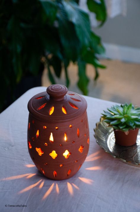 Handmade wheel thrown clay candleholder with beautiful cut-out pattern to give your space a bohemian touch! Be it your entryway or your zen corner, this unique candle holder is sure to give your home warm vibes with the beautiful pattern it creates. 100% natural & Eco-friendly, made with pure clay, and totally free of any toxic materials or lead. Perfect gift for any occasion! Dimensions 5.5 in Height (without lid) 7 in Height (with lid) 4.5 in Diameter at the widest. The TerracottaTales Edge Te Pottery Ideas Without Wheel, Thrown Ceramics Ideas, Terracotta Air Dry Clay Ideas, Terracotta Clay Crafts, Homemade Favors, Clay Candleholder, Ceramic Candle Holders Ideas, Terra Cotta Candle Holder, Candle Holder Pottery