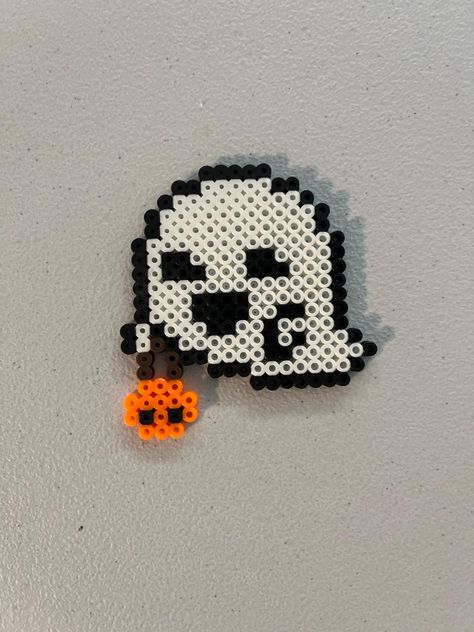 This is a keychain sized Halloween design made of Perler beads. Ghost Perler Beads Pattern, Perler Bead Tool Pattern, What To Do With Perler Bead Creations, Pony Beads Halloween, Halloween Beads Ideas, Perler Halloween Ideas, Perler Bead Patterns Coraline, Perler Bead Patterns Halloween Small, Iron Beads Spiderman