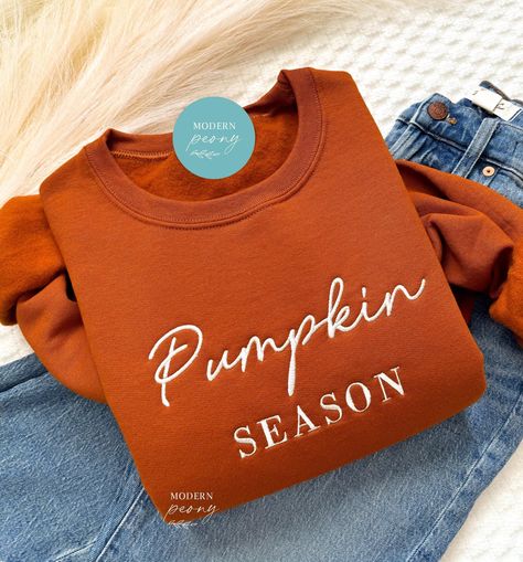 Fall Sweatshirt Embroidered, Pumpkin Season Pumpkin Crewneck Sweatshirt Pumpkin Shirt, Pumpkin Sweater, Autumn Shirt Thanksgiving Sweatshirt ---HOW TO ORDER---   FOR EACH SHIRT CHOOSE: **Shirt type, size and color ---UNISEX SIZING--   Please see size chart in the pictures ---PRODUCT DETAILS--- Gildan Crewneck UNISEX Sweatshirt 50% cotton, 50% polyester Pre-shrunk Air jet yarn for softer feel and reduced pilling Double-needle stitched collar, shoulders, armholes, cuffs, and hem Gildan Crewneck UN Fall Crewneck Sweatshirt Embroidery, Fall Custom Embroidery Sweatshirt Gift, Fall Embroidered Graphics Sweatshirt, Embroidered Pumpkin Sweatshirt, Pumpkin Crewneck, Embroidered Pumpkin, Pumpkin Sweater, Fall Crewneck, Fall Carnival