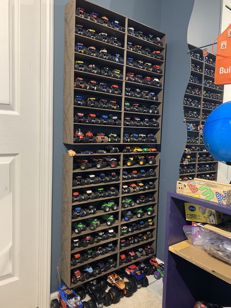 Toy Storage For Large Trucks, Monster Jam Playroom, Monster Jam Toy Storage, Monster Truck Toy Storage Ideas, Monster Truck Garage Diy, Monster Jam Storage Ideas, Monster Truck Wall Storage, How To Store Monster Trucks, Monster Truck Toy Storage