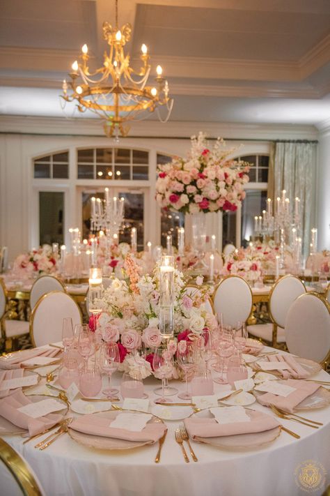 Kristi & Alex’s stunning country club wedding featured pink and white wedding decor. The outdoor ceremony included large pink and white floral arches draping over a mirrored aisle. The wedding reception featured gold and crystal decor with pink & white centerpieces, candelabras and pink glassware. | Floral, Decor, Production, Rentals: Royal Luxury Events / Photo: Jessica Frey Photography | wedding table centerpieces, low floral arrangements, wedding reception decor, pink wedding flowers, elegant Blush Pink Wedding Centerpieces Diy, White Pink And Gold Wedding Decor, Flowers On Candelabras Wedding, Table Reception Wedding, Dark Pink And Gold Wedding, Pink And White Debut Theme, Circle Wedding Centerpieces, Pink And White Engagement Decor, Pink Decor Table